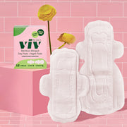 Viv Combo Pads: Eco-Friendly Winged Day Pads and Toxin-Free Night Pads with 2 sets of wings sit on a pink tile background with a box of Viv Bamboo Pads next to them