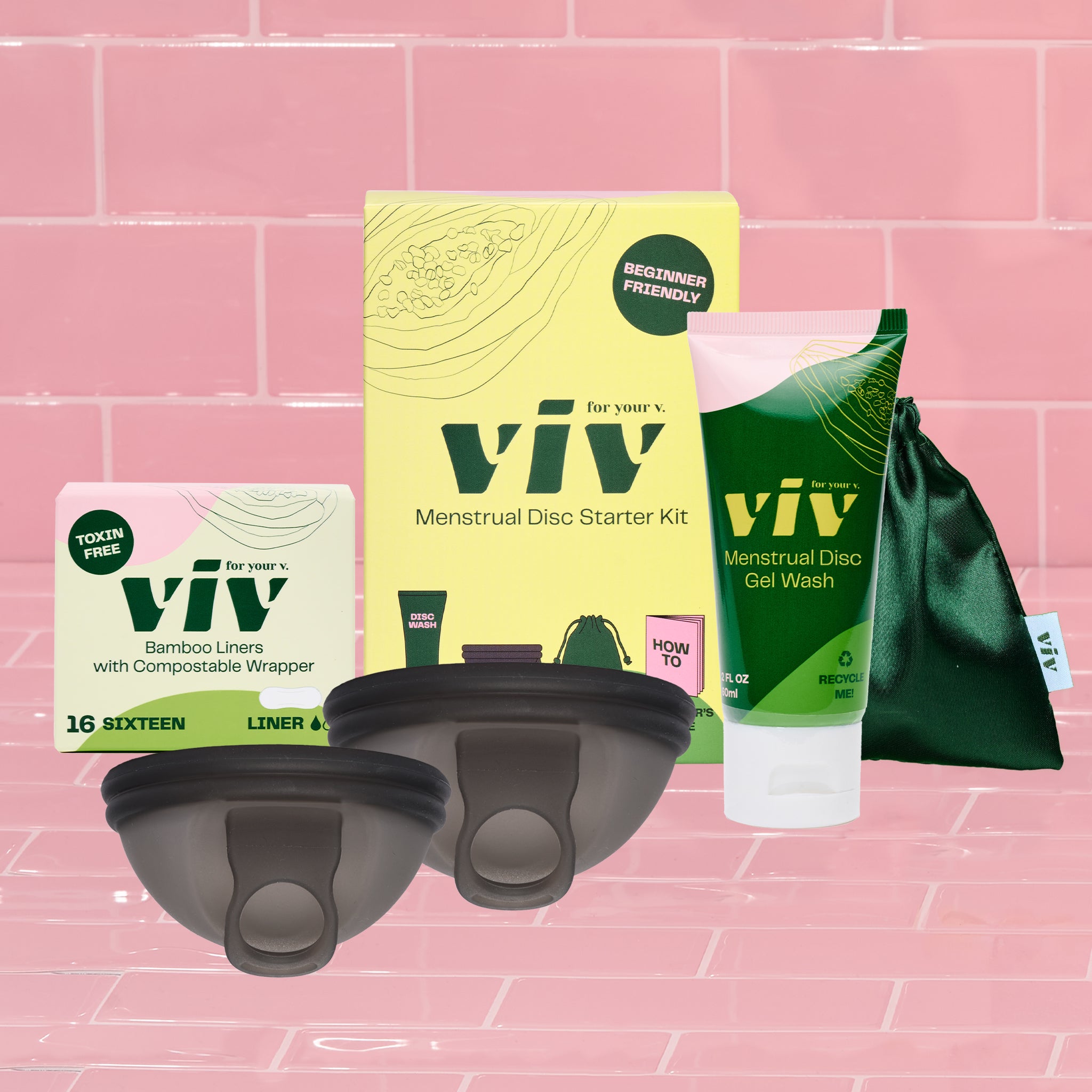 Become a menstrual disc expert with the Viv Disc Perfect Fit Kit! A Viv Menstrual Disc Starter Kit, Menstrual Disc Gel Wash, two Viv Menstrual Discs in sizes S/M and L, a Disc storage pouch, and a box of 100% toxin-free bamboo Viv panty liners all sit on a pink tile backdrop.